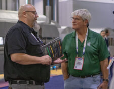 Robb Murray talking with two IPPE attendees