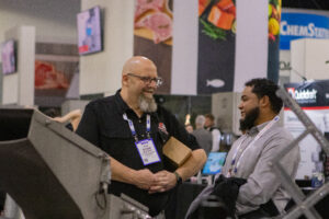Robb Murray talking to an IPPE attendee.